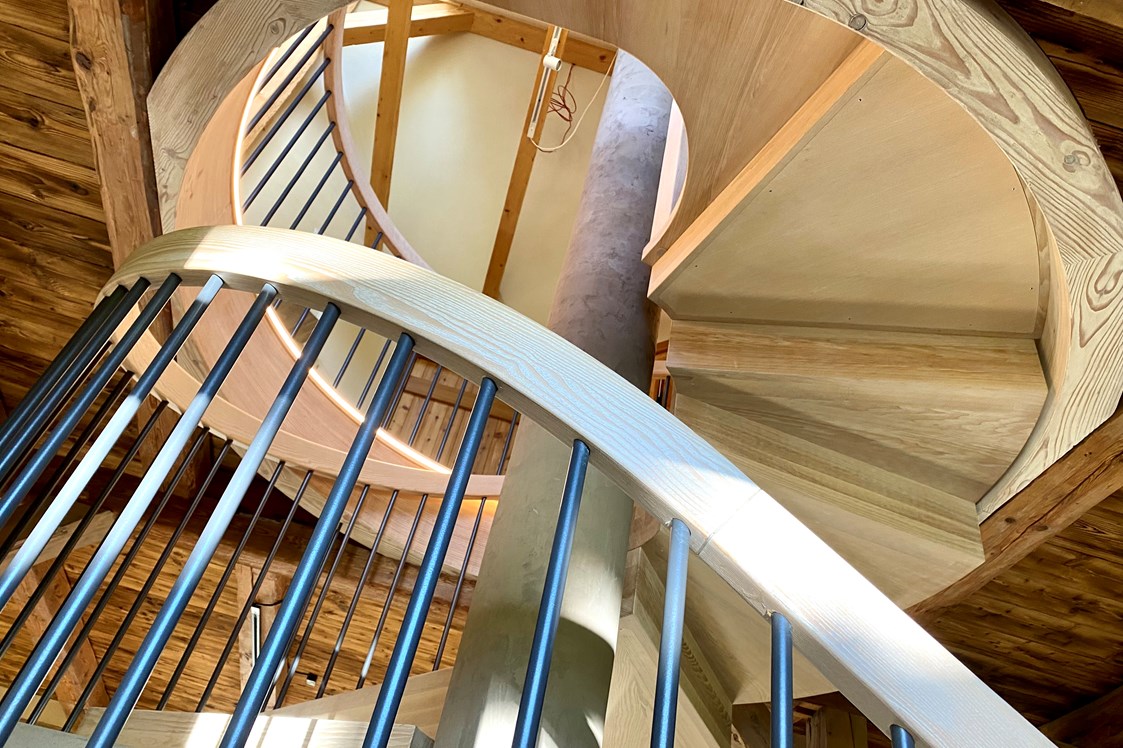 Biohotel: Ferienhaus "Rosenscheune", Treppe mit Ofen zum Obergeschoss - BIO-NATURIDYLL WIESENGRUND