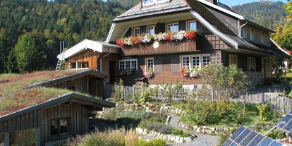 Naturhotel - PLZ 79804 (Deutschland) - Haus Sonne im Sommer, im Vordergrund der Kräutergarten und Solarpanels. - Haus Sonne - das vegetarische Bio-Hotel